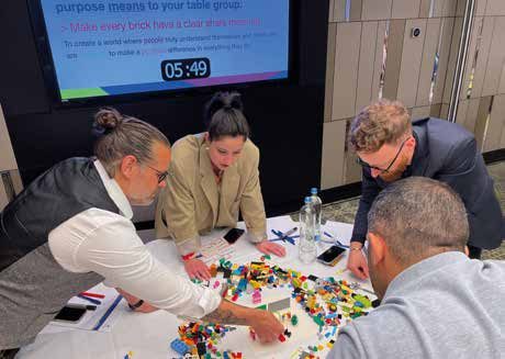 Leaders at The Insights Group each building their own answer at a shared table